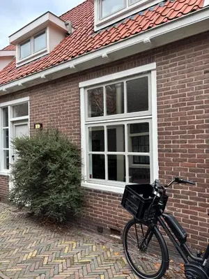 a bike parked in front of a brick house at Studio Fnidsen in Alkmaar
