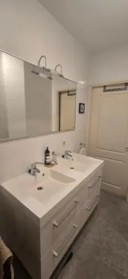 a bathroom with two sinks and a large mirror at Spacious Room with private king bathroom in Amsterdam