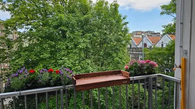 a balcony with flower boxes on a fence at Spacious Room with private king bathroom in Amsterdam