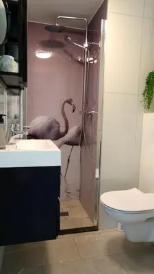 a bathroom with a flamingo in the shower at Delightful tropical retreat close to the sea in Warmenhuizen