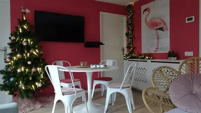a dining room with a christmas tree and a table and chairs at Delightful tropical retreat close to the sea in Warmenhuizen