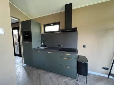 a kitchen with a sink and a stove at Rijn Residentie in Alphen aan den Rijn