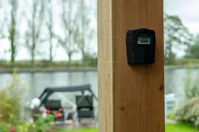 a clock on the side of a wooden pole at Rijn Residentie in Alphen aan den Rijn