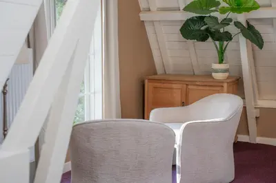 a room with two chairs and a table and a plant at The Guesthouse in Gouda