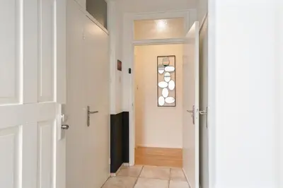 a hallway with a door open to a hallway with a hallway at Seebrise Apartment with parking in Zandvoort