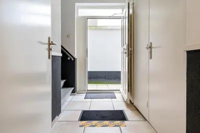 a hallway with a door leading to a bathroom at Seebrise Apartment with parking in Zandvoort
