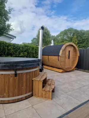 a wooden dog house and a bench on a patio at TETchalet met wellness tuin in Berkhout