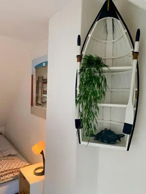 a room with a plant on a wall at Vakantiehuis Castor 300 m van het strand in Noordwijk aan Zee