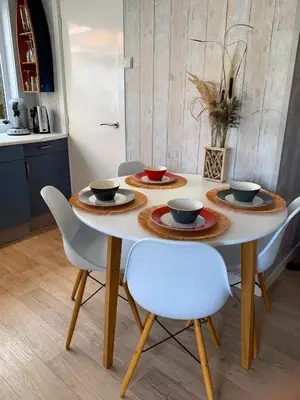 a table with bowls and plates on it in a kitchen at Vakantiehuis Castor 300 m van het strand in Noordwijk aan Zee
