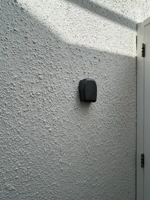 a black object on the side of a white wall at The Surf House Noordwijk in Noordwijk aan Zee