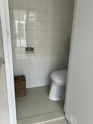 a bathroom with a toilet and a shower at The Surf House Noordwijk in Noordwijk aan Zee