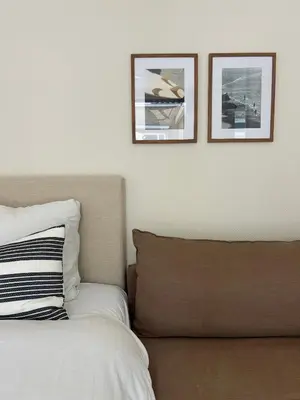 a bedroom with two pictures on the wall and a bed at The Surf House Noordwijk in Noordwijk aan Zee