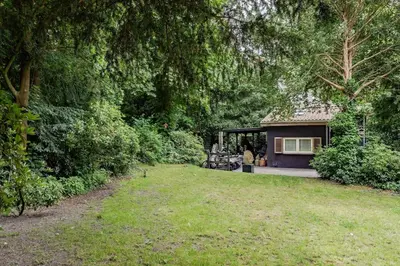 a house in a yard with a grass field at Villa Nolan in Bergen