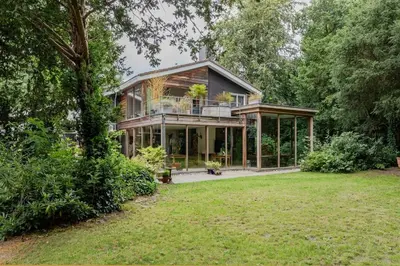 a large house with a porch and a large yard at Villa Nolan in Bergen