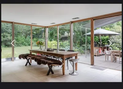 a dining room with a table and chairs and windows at Villa Nolan in Bergen