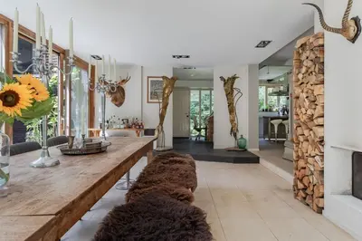 a living room with a wooden table and a fireplace at Villa Nolan in Bergen