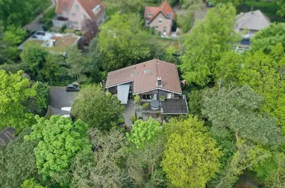 an aerial view of a house in the middle of trees at Villa Nolan in Bergen