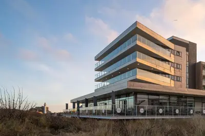 a tall office building with glass windows at Droomsuites Egmond aan Zee 4 personen by Droomvilla in Egmond aan Zee