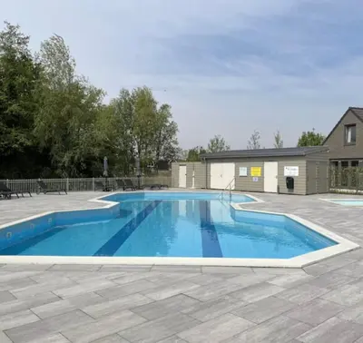 a large blue swimming pool in a yard at De Wielen 23 in Sint Maarten