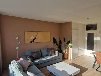 a living room with a couch and a table at Kintsugi in Alphen aan den Rijn