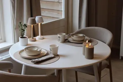 a white table with plates and candles on it at Maison Côte - Moderne Studio met Privé Tuin, Nabij Strand & Circuit in Zandvoort