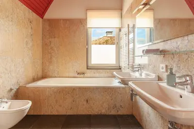 a bathroom with two sinks and a bath tub at 10P 4B Luxe Villa with Pool and Sauna in Spijkerboor in Spijkerboor