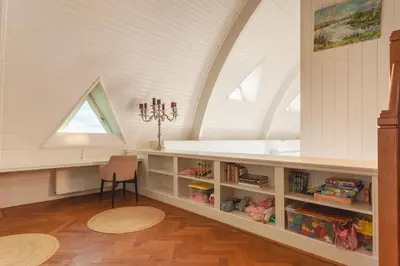 a attic room with a desk and a window at 10P 4B Luxe Villa with Pool and Sauna in Spijkerboor in Spijkerboor