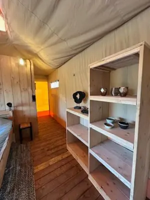 a room with wooden floors and a room with shelves at Safari Lodge at Back to Basic in Zwaanshoek