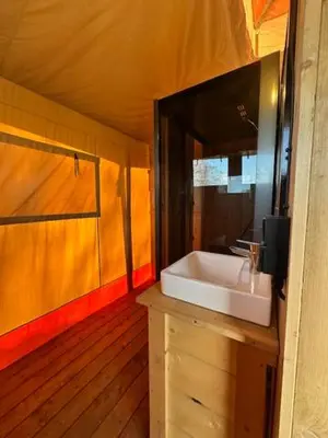 a bathroom with a sink and a mirror at Safari Lodge at Back to Basic in Zwaanshoek