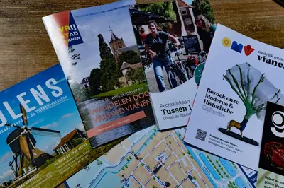 a bunch of publications sitting on a table at Huize de Lekpoort - The City View - Historic Apartment in Vianen Center in Vianen