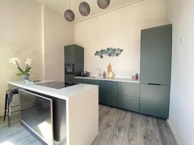 a kitchen with blue and white cabinets and a counter at Huize de Lekpoort - The City View - Historic Apartment in Vianen Center in Vianen