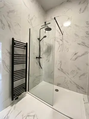 a shower with a glass door in a bathroom at Huize de Lekpoort - The City View - Historic Apartment in Vianen Center in Vianen