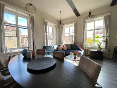 a living room with a table and a couch at Huize de Lekpoort - The City View - Historic Apartment in Vianen Center in Vianen