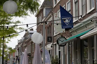 a street with a clock on a building at Huize de Lekpoort - The City View - Historic Apartment in Vianen Center in Vianen