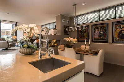 a kitchen with a sink and a table with chairs at Executive Houseboat-Apartment Sumatra in Amsterdam