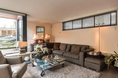 a living room with a couch and a table at Executive Houseboat-Apartment Sumatra in Amsterdam