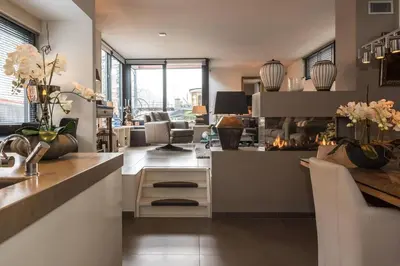 a kitchen with a counter and a living room at Executive Houseboat-Apartment Sumatra in Amsterdam