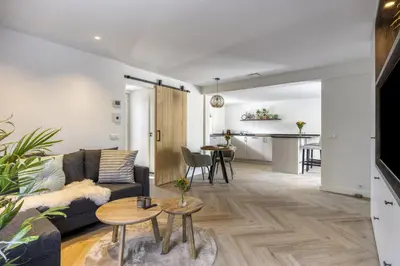 a living room with a couch and a table at Cosy Nest in Noordwijk aan Zee