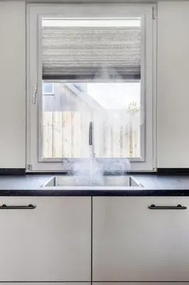 a kitchen with a sink and a window at Cosy Nest in Noordwijk aan Zee