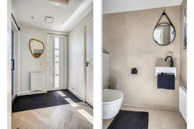 a bathroom with a white toilet and a mirror at Cosy Nest in Noordwijk aan Zee
