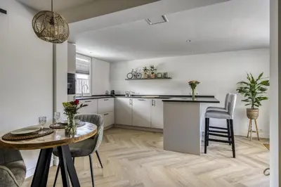 a kitchen and dining room with a table and chairs at Cosy Nest in Noordwijk aan Zee