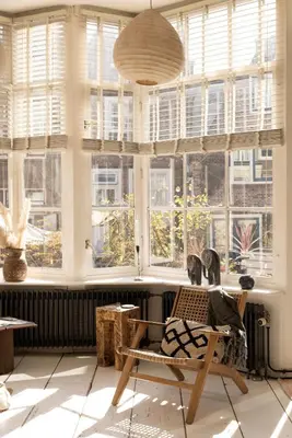a room with windows with a chair in front of it at The Bright Loft - City Centre Amsterdam in Amsterdam