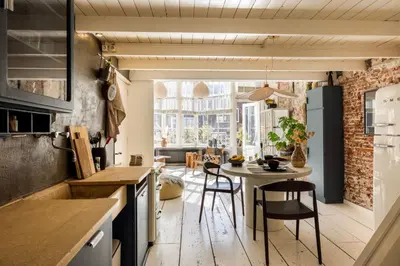 a kitchen with a table and chairs in a room at The Bright Loft - City Centre Amsterdam in Amsterdam