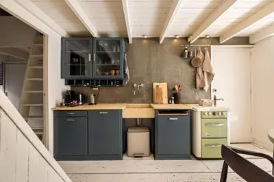 a kitchen with blue cabinets and a green stove at The Bright Loft - City Centre Amsterdam in Amsterdam