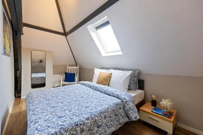 a bedroom with a bed and a skylight at Elegant City Apartment in the Heart of Gouda in Gouda