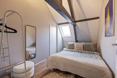 a bedroom with a bed and a mirror at Elegant City Apartment in the Heart of Gouda in Gouda