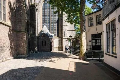 a group of people walking down a street in a building at Elegant City Apartment in the Heart of Gouda in Gouda