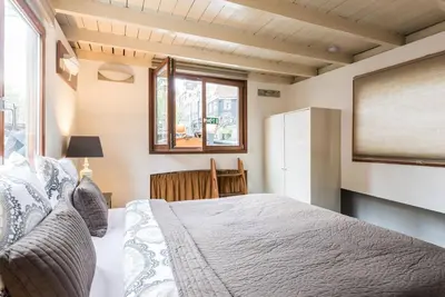 a bedroom with a bed and a large window at Luxury Houseboat Prince-William in Amsterdam