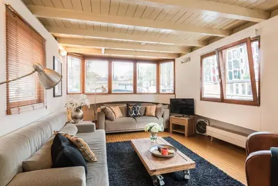 a living room with a couch and a table at Luxury Houseboat Prince-William in Amsterdam