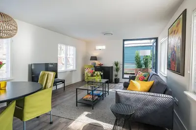 a living room with a couch and a table at Luxury Houseboat-Apartment Lady Jane in Amsterdam